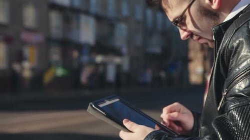 Businessman Using a Digital Tablet Pad in the Financial City
