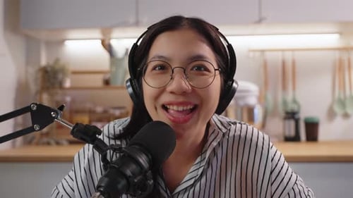 Woman Recording Podcast in Kitchen with Microphone