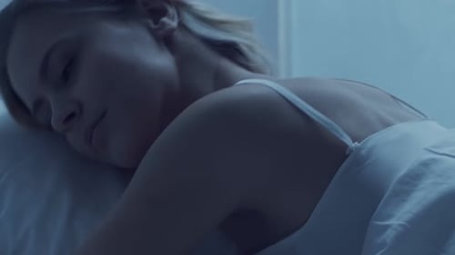 Woman Sleeping Peacefully in Bed at Night