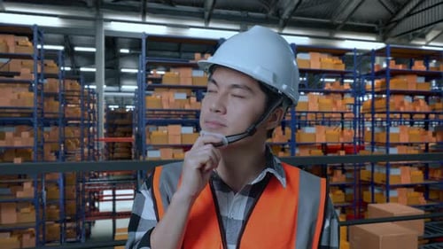 Close Up Of Asian Male Engineer Thinking And Looking Around The Warehouse