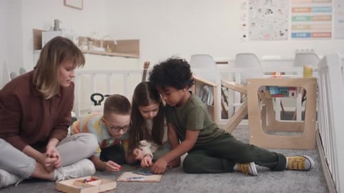 Children Play Game With Teacher in Classroom