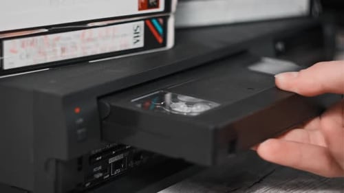 Insert VHS Cassette Into VCR Player and Push Play Button