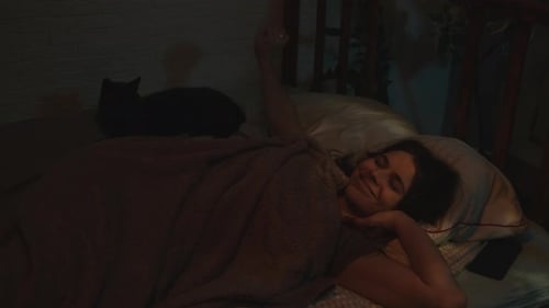 Woman Wakes Up and Pets Cat in Bed
