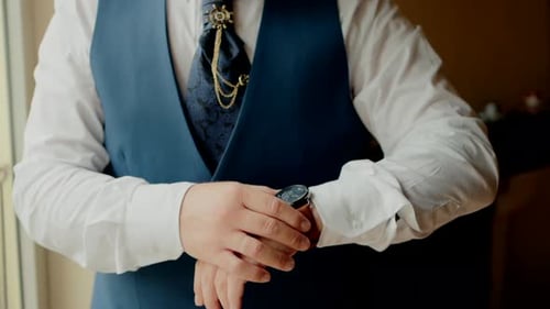 Man Checks Elegant Watch Before a Special Occasion