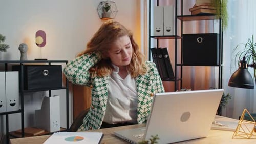 Business Woman Suffers From Spine Neck Muscle Pain at Home Office Workplace Working on Laptop