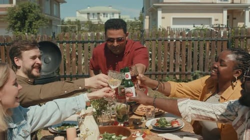 Friends Celebrate with Drinks at Backyard Table