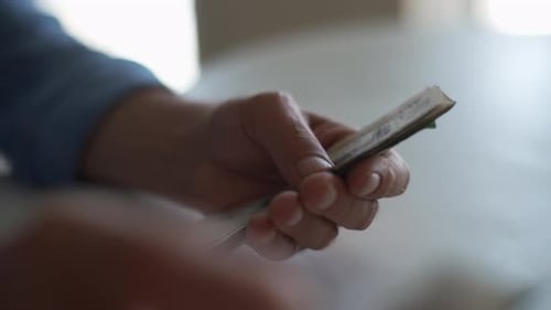 Closeup Side View of Unrecognizable Senior Adult Male with Wrinkled Hands Counting Russian Ruble