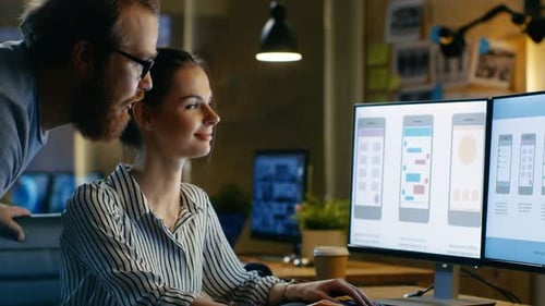 Female UX Architect Has Discussion with Male Design Engineer, They Work on Mobile Application Late