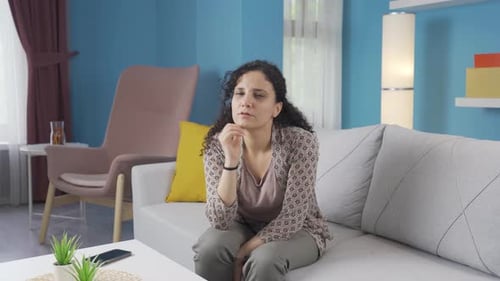 Woman Thinking and Pondering on Sofa