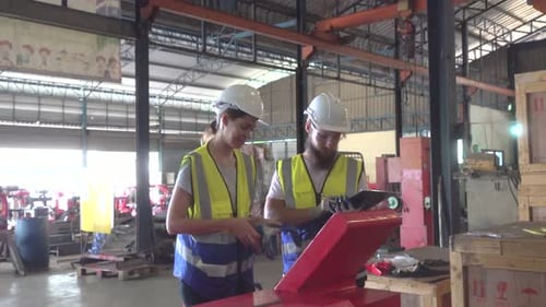 Industrial engineer working with automated arm robot inside AI robotic production factory.Technology