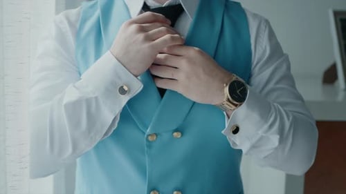 Man Adjusts Black Tie Preparing for Event