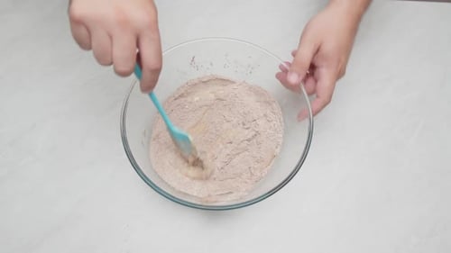 Mixing Ingredients for Chocolate Cake in Glass Bowl