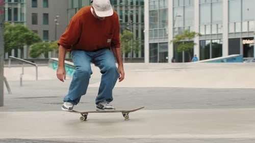 Young Skater Making 360 Flip Jump Performing Kickflip Trick Skateboarder Training in Skatepark