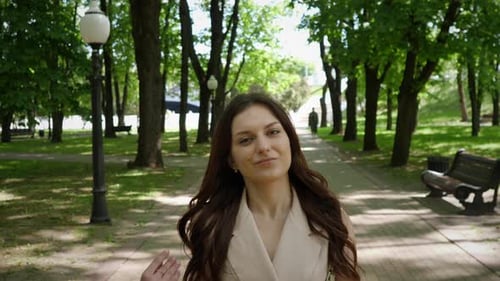 Beautiful Stylish Young Girl Portrait Walking Through a City Park