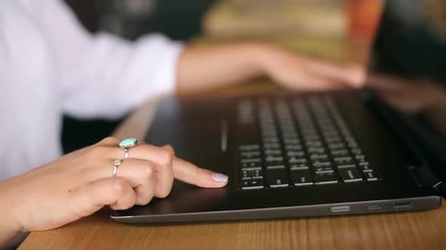 Close Up of Woman Touching Laptop Fingerprint Sensor with Her Finger to Login Biometric Fingerprint