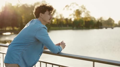 Young Bearded Caucasian Man Standing on the Waterfront of the River Dreaming Male Thinking About His