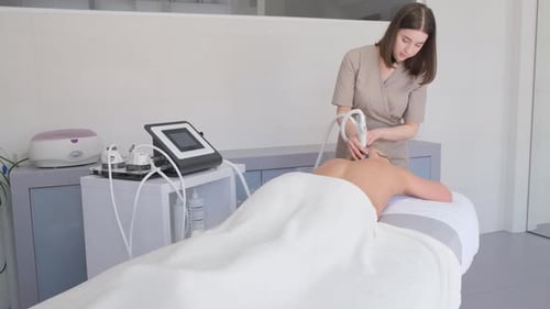 Woman Provides Healthcare Treatment in Clinic