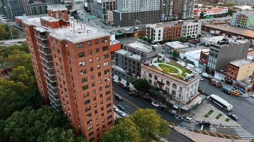 Urban landscape with blocks of flats and roads. Green areas on the tops of the houses.