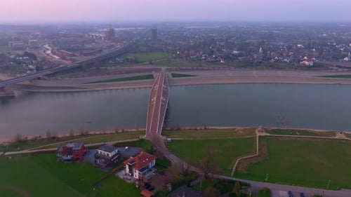 Aerial view of sunset over Waal river with rowers gliding near Nijmegen