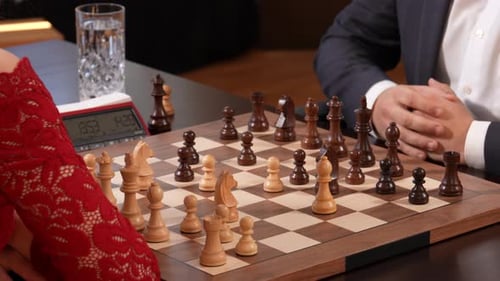 Hands of elegant woman and man playing chess game. Static shot