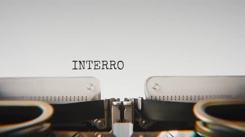 Old mechanical typewriter typing Interrogation Started in a close-up view.