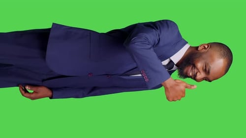 Vertical Video Side View of Male Employee Showing Thumbs Up Sign on Camera