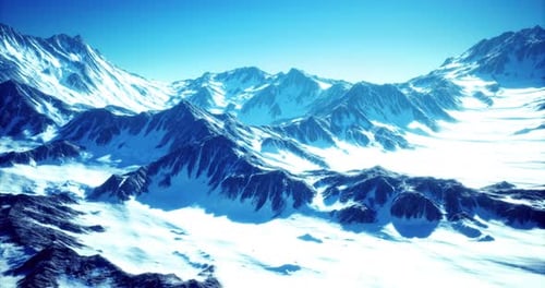 Aerial Flyover Over Majestic Snow-Covered Mountain Peaks