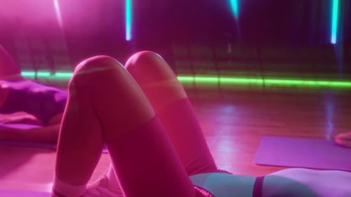 Retro Fitness Instructor and Class Participants Performing Glute Bridge at Gym