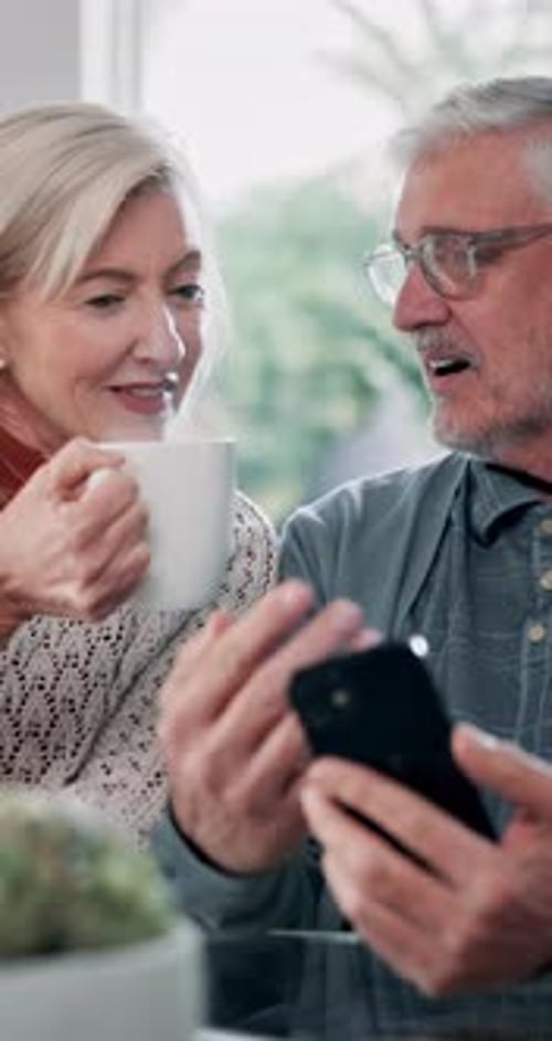 Senior Couple Enjoys Smartphone at Home Together