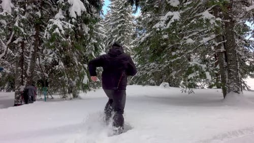 Man Running Away In Winter Forest