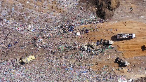 Aerial View of Landfill with Bulldozers and Truck