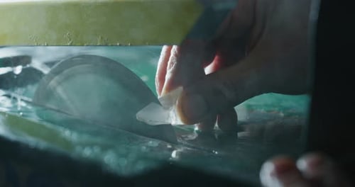 Slow motion close up of experienced goldsmith working on high quality aquamarine stones selected f