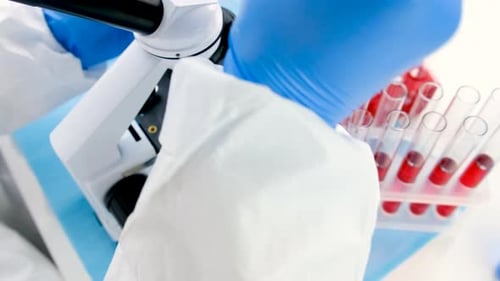 Microscope and test tubes in laboratory