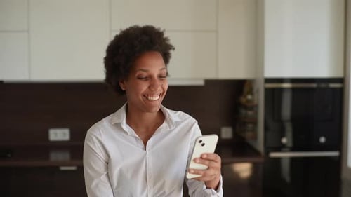 Woman Smiling and Gesturing During Smartphone Video Call