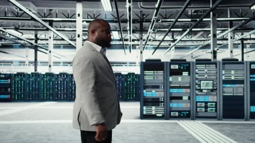 System Administrator Walking in Data Center with Rigs Doing Backups