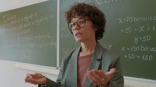 Female Teacher Giving a Math Lecture in Classroom