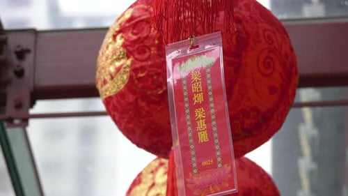 Red lantern and lucky charm hung in a temple, a prayer for good fortune.