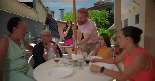 Family Enjoying Backyard Barbecue on Sunny Day