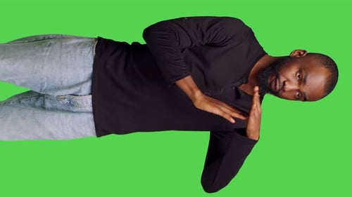 Vertical Video Front View of Confident Casual Man Expressing Timeout Gesture in Studio