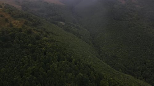Aerial Panoramic View Low Clouds in the Cloudy Weather Over Mountains Drone Flies Backward