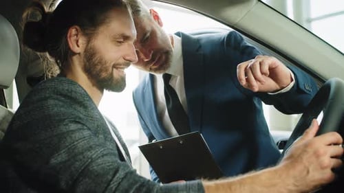 Portrait of Handsome Young Man Taking Luxury Car for Test Drive Sitting Inside
