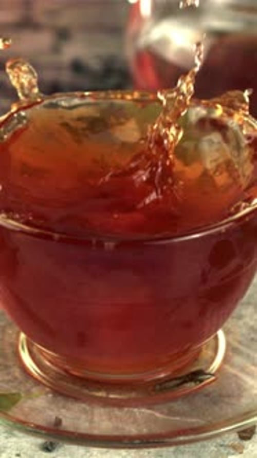 Super Slow Motion in a Cup of Tea Drops a Piece of Sugar with Splashes Filmed on a Highspeed Camera