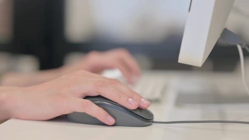 Side View of Woman Using Computer Mouse