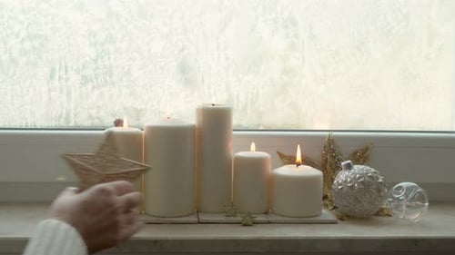 Festive Candles and Decorations on Windowsill During Daytime