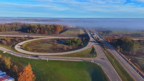 Highway I-96 exit in Lake Odessa, Michigan, USA with autumn colors and morning fog