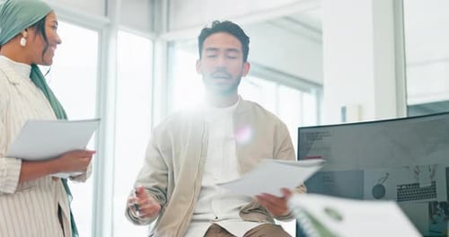 Talking businessman, mentor or designer meeting on paper, documents or review in office