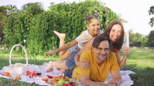 Happy Family Picnic in Green City Park