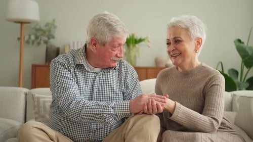 Affectionate Senior Couple Holding Hands and Smiling