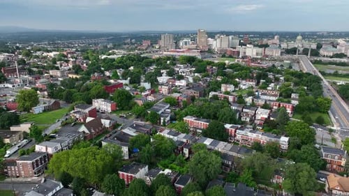 American city during summer. Aerial of residential homes and city skyline.