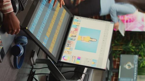 Photo Editor Using Dual Monitors at Desk